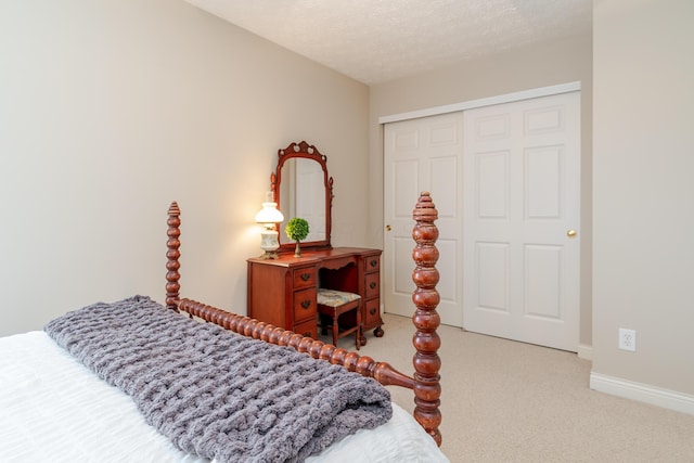 carpeted bedroom with a textured ceiling, baseboards, and a closet