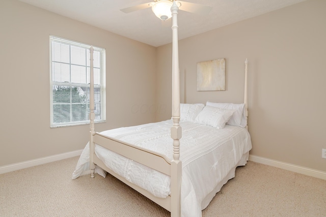 bedroom with light carpet, ceiling fan, and baseboards