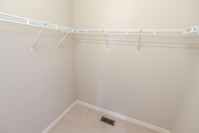 walk in closet with carpet flooring and visible vents