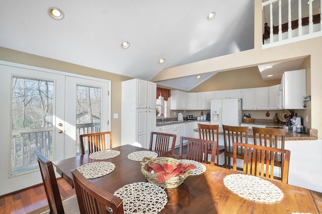 dining area featuring recessed lighting, french doors, high vaulted ceiling, and light wood finished floors