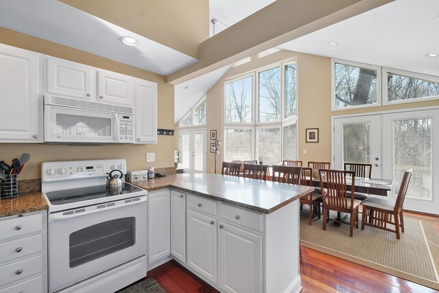 kitchen featuring french doors, white appliances, wood finished floors, and white cabinetry