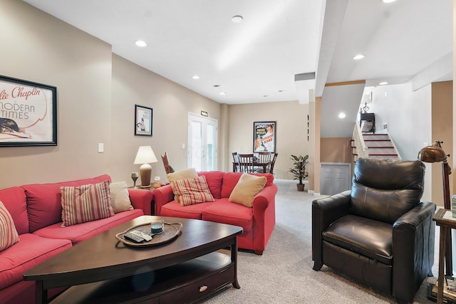 living area with stairs, recessed lighting, light colored carpet, and baseboards