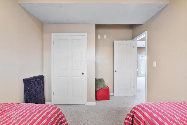 bedroom featuring baseboards and carpet flooring