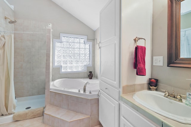 bathroom with vaulted ceiling, a tile shower, a bath, tile patterned floors, and vanity