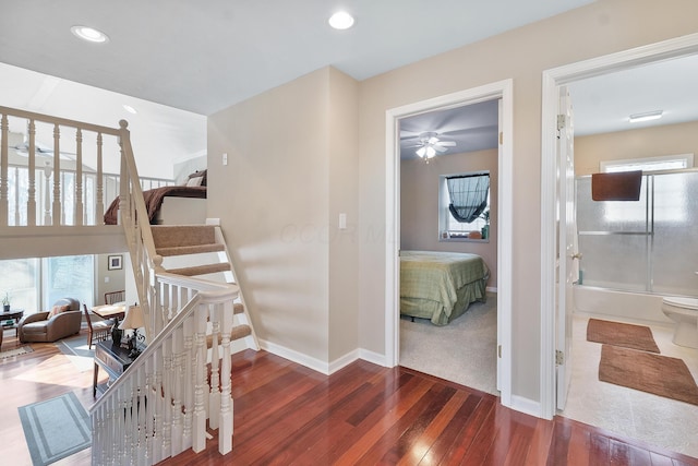 staircase featuring recessed lighting, baseboards, and wood finished floors