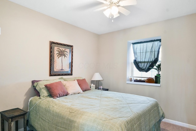 carpeted bedroom featuring a ceiling fan and baseboards