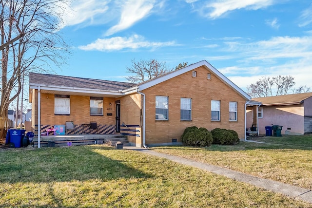 bungalow-style house with crawl space, brick siding, and a front lawn