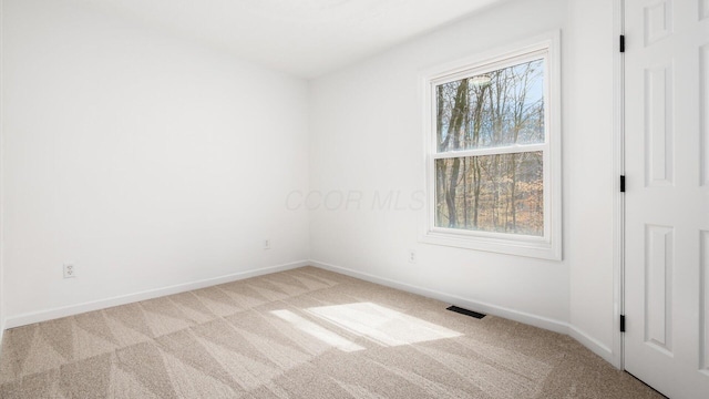 unfurnished bedroom with carpet flooring, visible vents, and baseboards