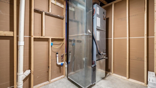 bathroom with heating unit and unfinished concrete floors