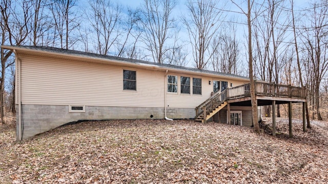 back of house with stairs and a wooden deck