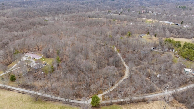 drone / aerial view featuring a forest view