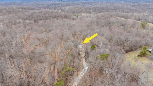 birds eye view of property featuring a wooded view