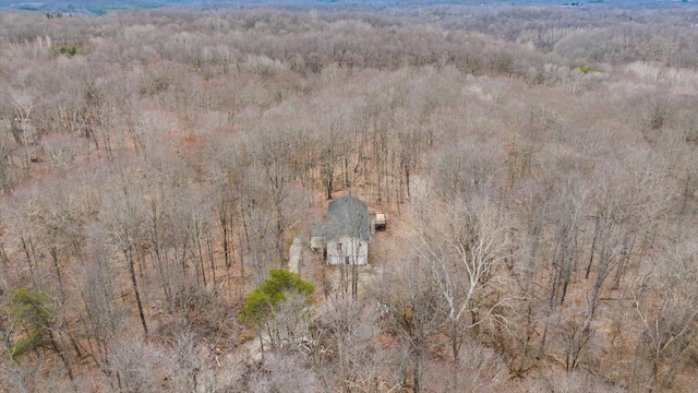 drone / aerial view with a wooded view