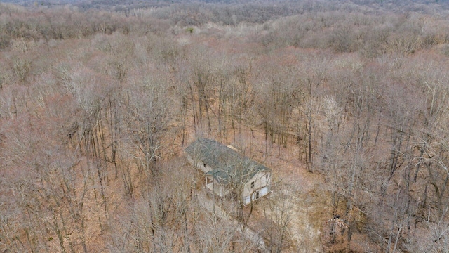 drone / aerial view featuring a wooded view