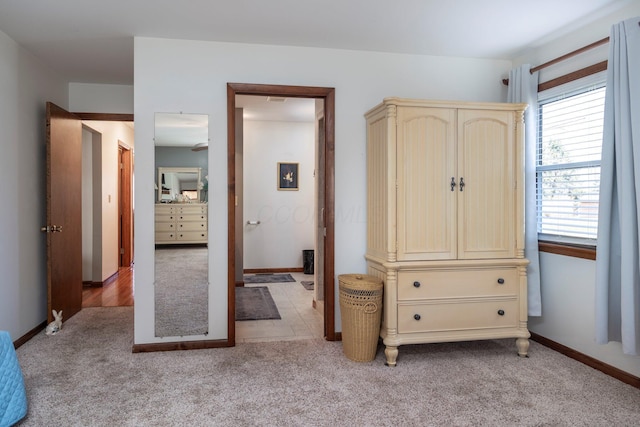 bedroom featuring baseboards and light colored carpet