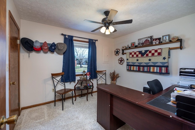 office with baseboards, light carpet, a textured ceiling, and ceiling fan