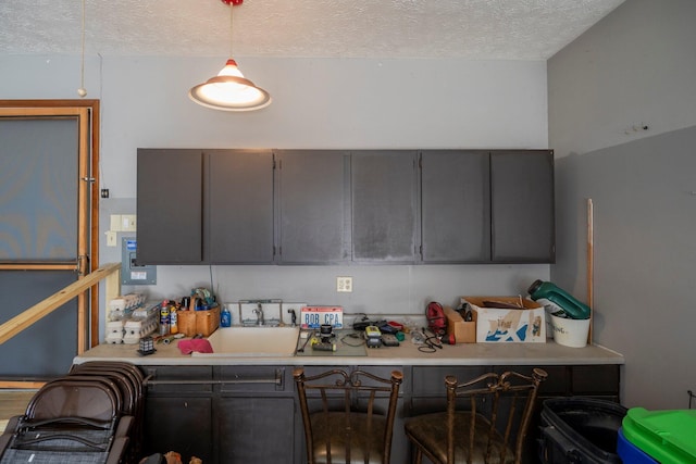 kitchen featuring light countertops, gray cabinets, and a textured ceiling