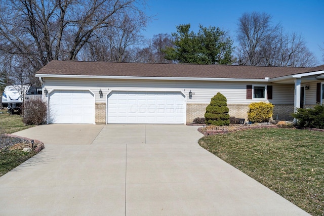 view of front facade featuring a garage, brick siding, concrete driveway, and a front lawn