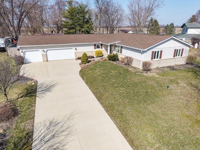 ranch-style house featuring an attached garage, roof with shingles, concrete driveway, and a front lawn