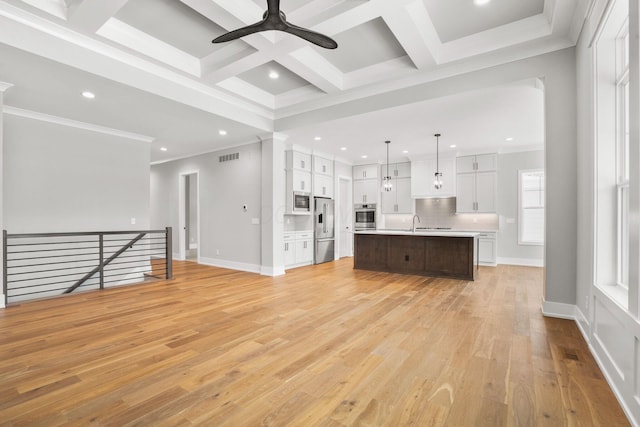 unfurnished living room with baseboards, coffered ceiling, beamed ceiling, light wood-type flooring, and recessed lighting