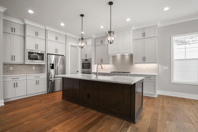 kitchen with ornamental molding, appliances with stainless steel finishes, a sink, and dark wood-style floors