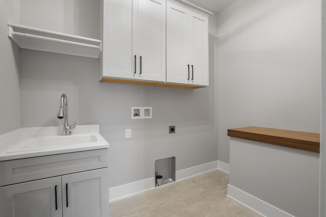 laundry area featuring hookup for a washing machine, cabinet space, hookup for an electric dryer, a sink, and baseboards