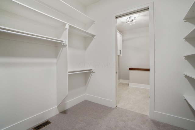 walk in closet with carpet and visible vents