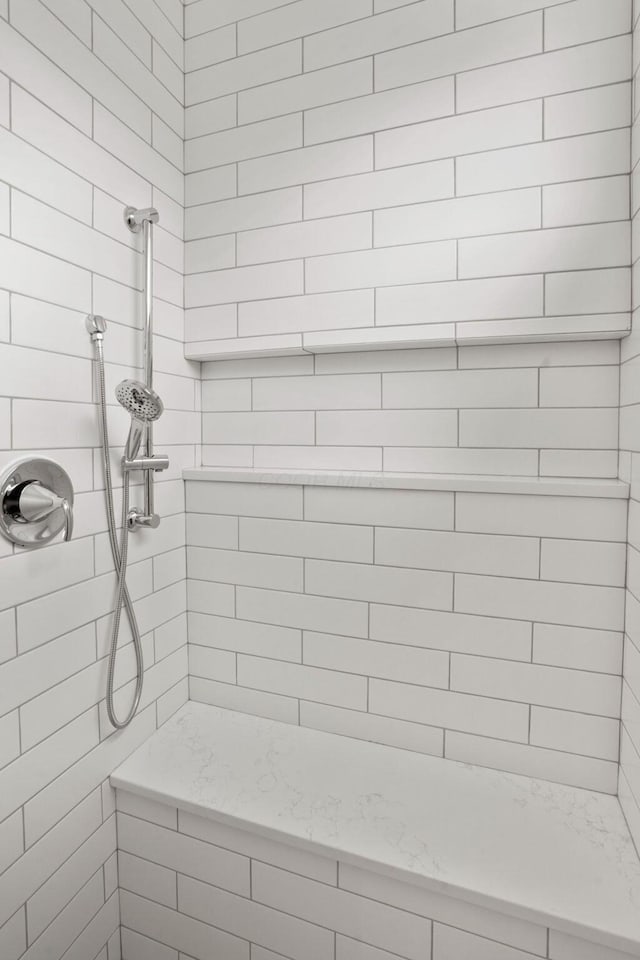 bathroom with a tile shower