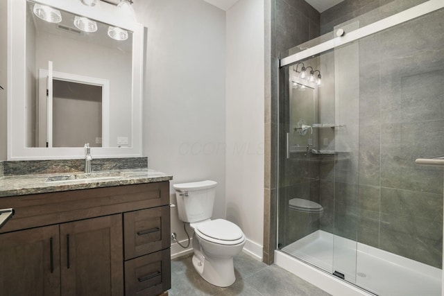 bathroom featuring a stall shower, baseboards, toilet, tile patterned flooring, and vanity