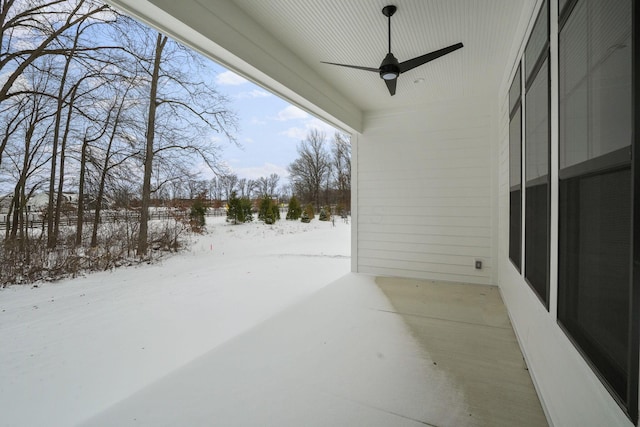 snow covered patio featuring a ceiling fan