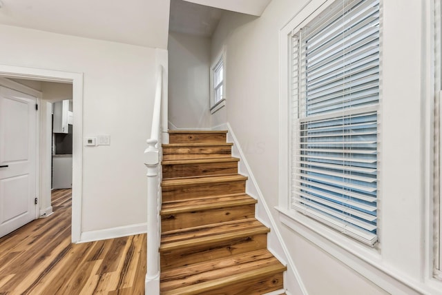 stairs featuring baseboards and wood finished floors