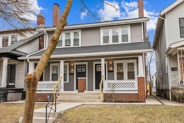 view of front of property featuring a porch, a shingled roof, a chimney, and a front lawn