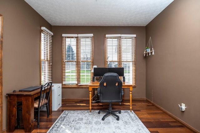 office area with baseboards, dark wood-type flooring, and a textured ceiling