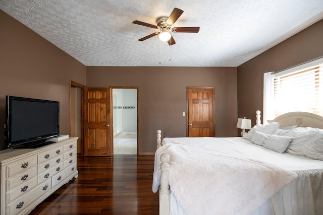 bedroom featuring a textured ceiling, ceiling fan, and dark wood finished floors