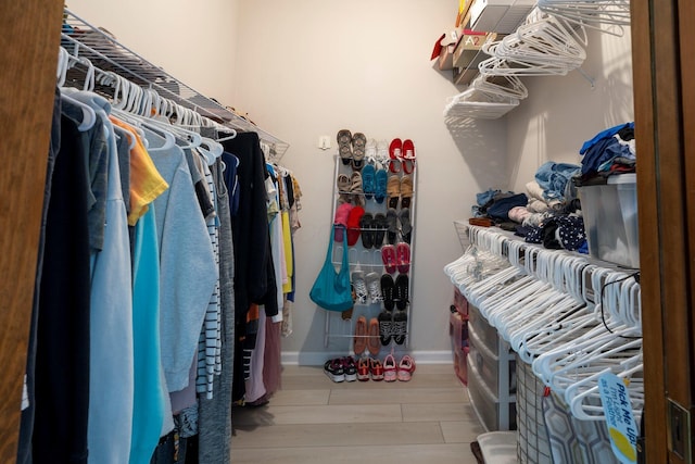 walk in closet featuring wood finished floors