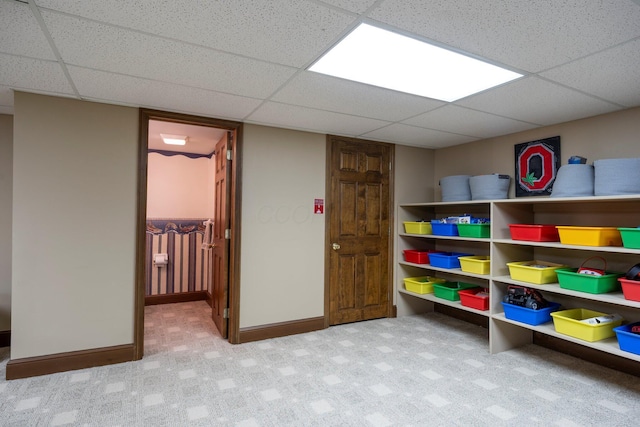 rec room featuring carpet flooring, baseboards, and a paneled ceiling