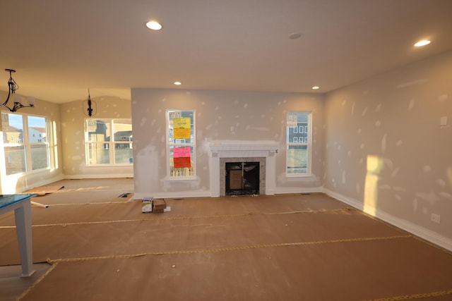 unfurnished living room featuring recessed lighting, visible vents, baseboards, and a tile fireplace