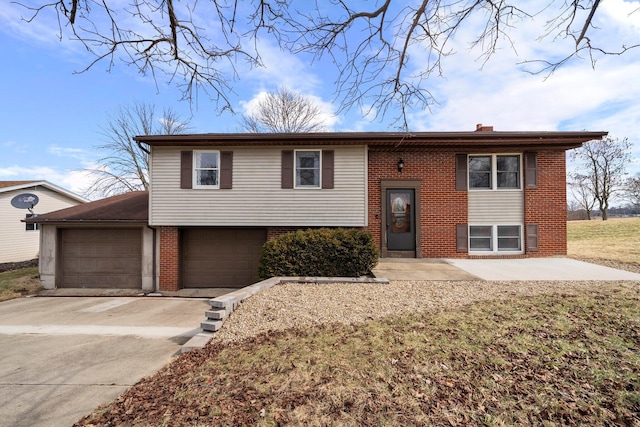 raised ranch with a garage, brick siding, concrete driveway, a front lawn, and a chimney