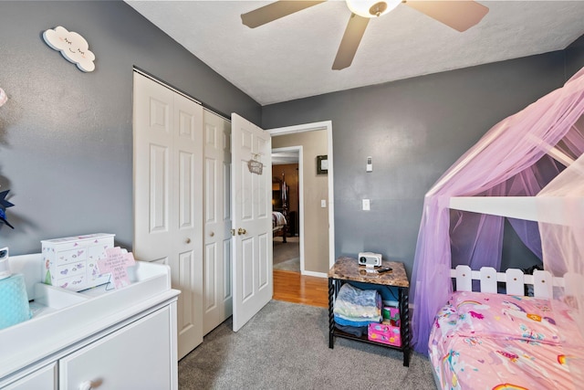 bedroom featuring carpet, a closet, ceiling fan, a textured ceiling, and baseboards
