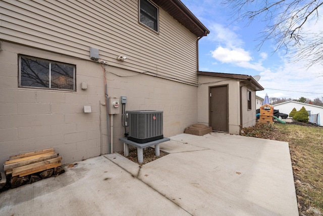 exterior space with a patio area and central air condition unit