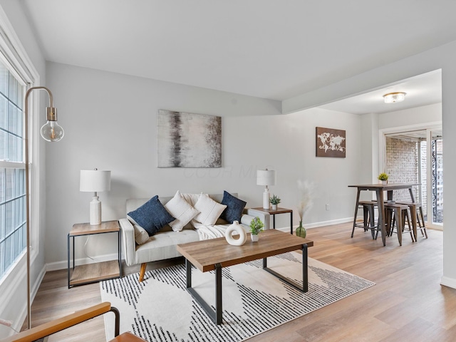 living room with light wood-style flooring and baseboards