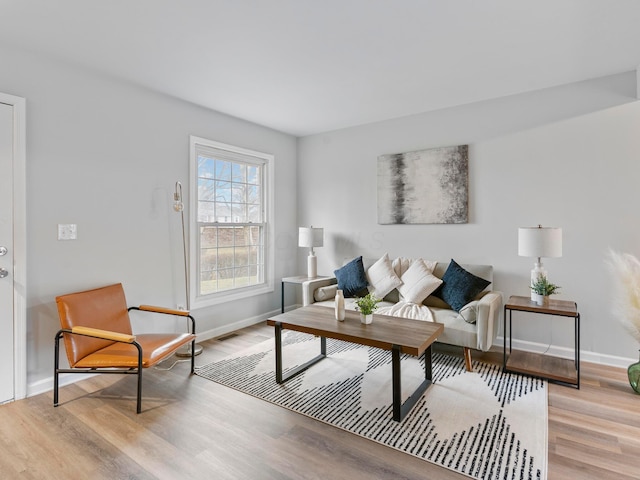 living room featuring light wood finished floors and baseboards