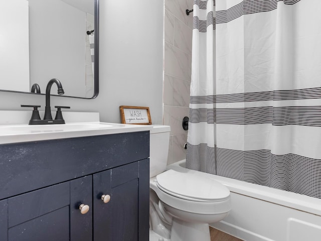 bathroom with toilet, wood finished floors, vanity, and shower / tub combo with curtain