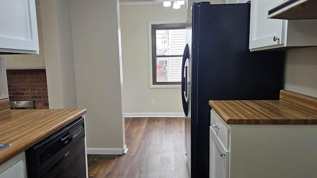 kitchen with baseboards, under cabinet range hood, dark wood-style floors, white cabinets, and black appliances