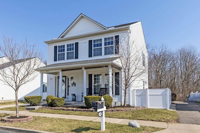 view of front of house featuring a porch and fence