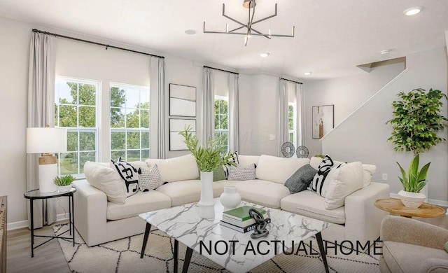 living area with a healthy amount of sunlight, light wood-type flooring, and recessed lighting