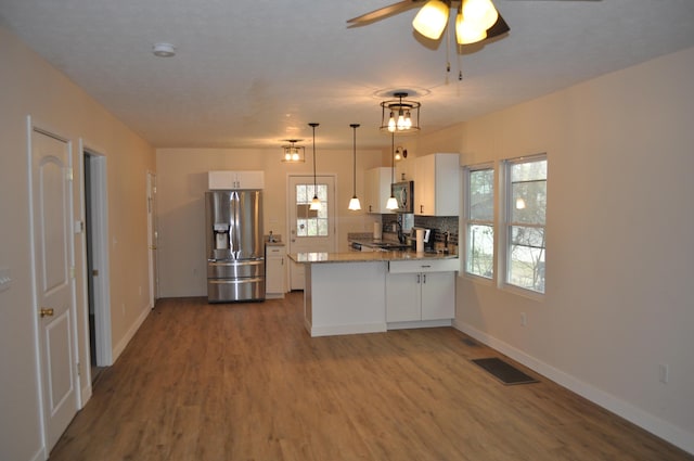 kitchen featuring wood finished floors, visible vents, white cabinetry, and stainless steel appliances