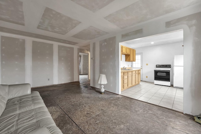 unfurnished living room with coffered ceiling and a sink