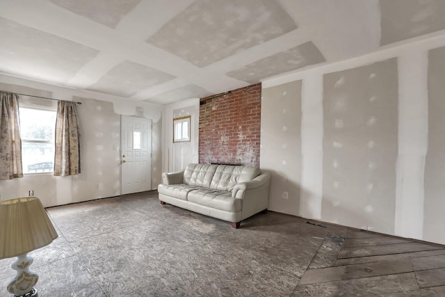 unfurnished living room featuring coffered ceiling