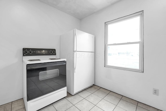 kitchen with white appliances and light tile patterned flooring